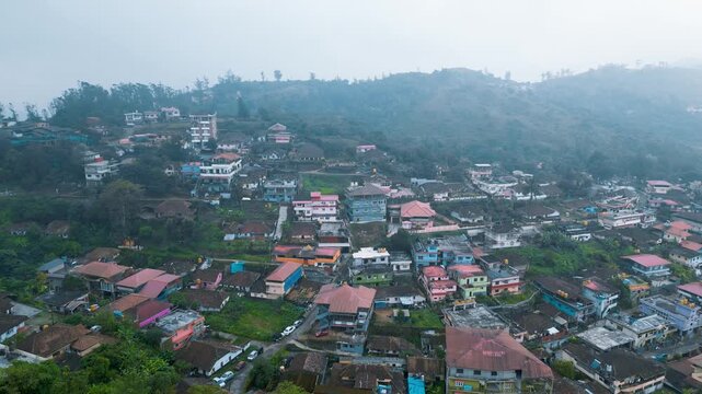 Foggy mountain village of Madikeri in India aerial view with colorful houses