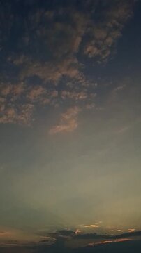 Dramatic Sunset Sky with Fluffy Cumulus Clouds and Golden Sunlight Rays Vertical Video
