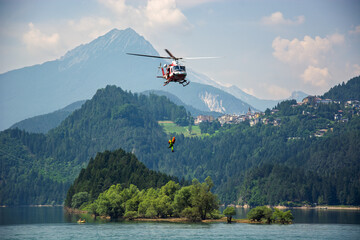 Emergency operations on the lake with helicopters dropping rescuers for the shipwrecked © corradobarattaphotos