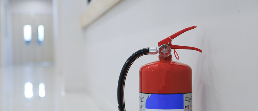 Fire extinguisher system on the wall background.close-up of a fire extinguisher showcasing safety equipment.
