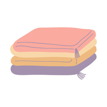 Stack of folded blankets with tassels
