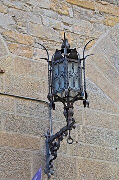 old street lantern in Florence, Italy on stone wall