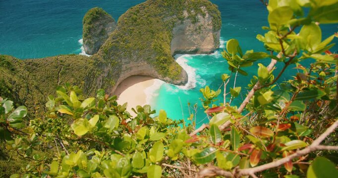 Kelingking Beach on Nusa Penida Island Bali shows iconic cliff formation and blue ocean