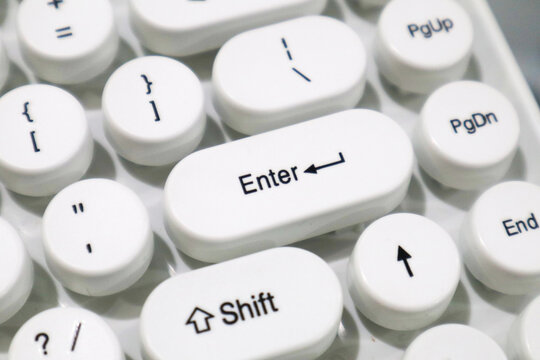 Close-up of a white typewriter style mechanical keyboard with Enter and Shift keys