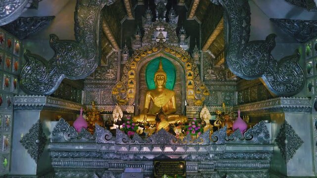 Ornate golden Buddha statue inside Chiang Mai Silver Temple Wat Sri Suphan