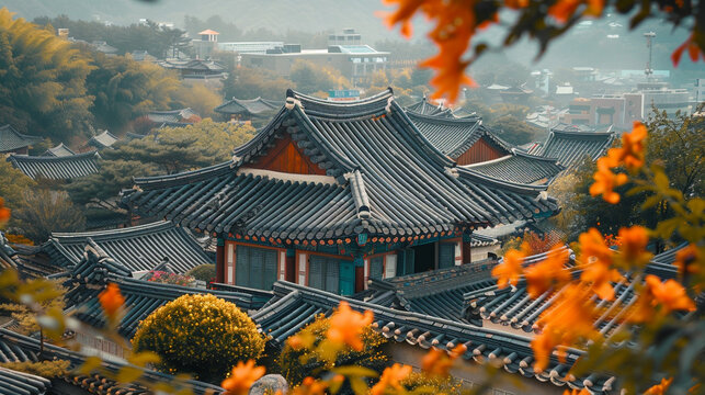Traditional Korean Hanok Village Roofs Framed by Orange Autumn Flowers
