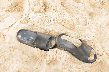 Black beach flip-flops on the sand in Ukraine, themed around summer vacations, beaches © Виктория Котлярчук