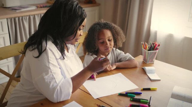 Primary education practicing with little girl, child and adult woman drawing. Homeschooling and kids development, african american female psychologist and little patient, pediatric neuropsychology