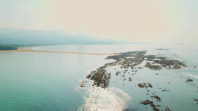 Drone view of coastal reef and long sandbar at Marino Ballena National Park Costa Rica