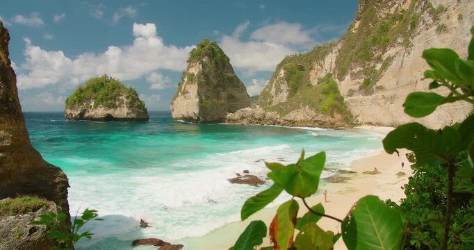 Stunning tropical cove with white sand and turquoise ocean water under blue sunny sky