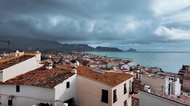 Aerial pan over Altea rooftops and Mediterranean coastline, Costa Blanca, Spain