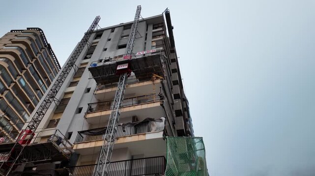 Tower building with construction scaffolding and crane, Calpe, Spain