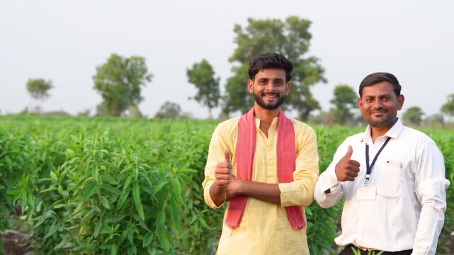 Young indian farmer and agronomist or banker showing thumps up 