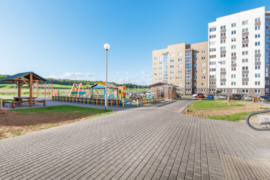 Residential Courtyard View with Playground and Modern Apartment Buildings