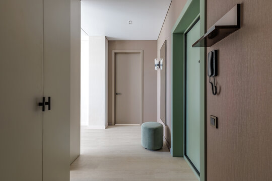 Modern Apartment Hallway Interior with Wardrobe, Fluted Door, and Pouf