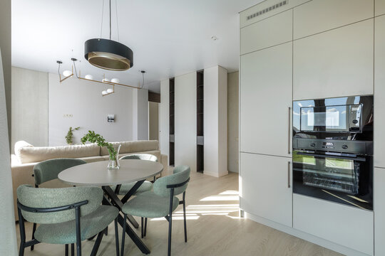 Modern Open-Plan Kitchen and Dining Interior with Built-In Appliances