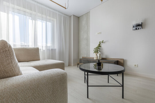 Modern Living Room Interior with Oval Glass Coffee Table and Sofa