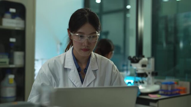 Researcher testing water purity through a microscope, monitoring soil moisture and crop health in a modern laboratory, advancing agricultural science and sustainability.
