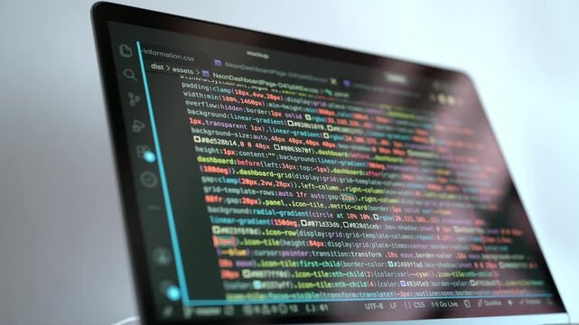 Close-up of a software development screen displaying colorful stylesheet code, web interface components, layout properties, and programming syntax in a dark coding workspace for frontend design.