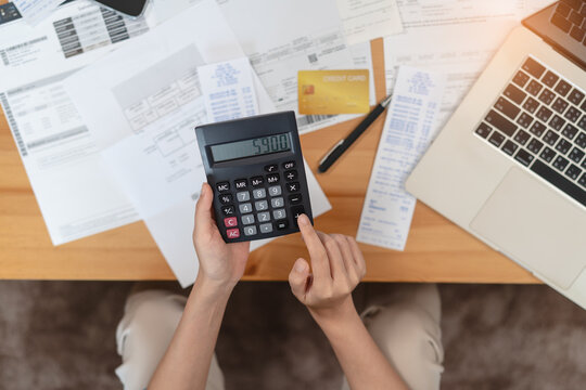 Woman doing accounting home finance expenses and calculate credit card monthly debt to bills payment