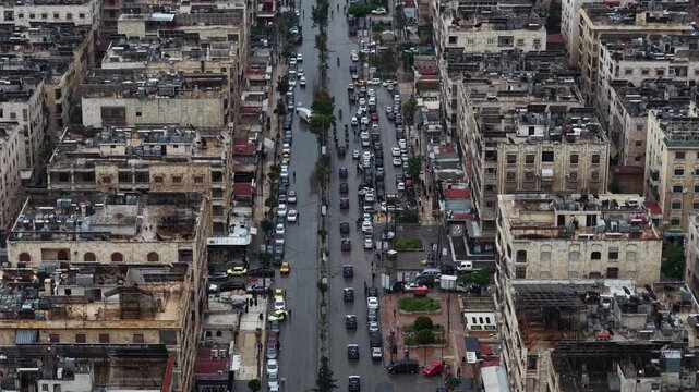Aerial drone view of tourism police vehicles and officers in Aleppo, Syria. Syrian tourism police convoy driving through city streets after the fall of Bashar al-Assad. New Syrian government security 