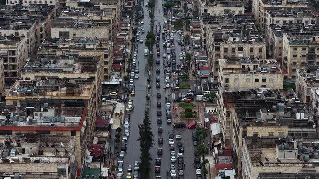 Aerial drone view of tourism police vehicles and officers in Aleppo, Syria. Syrian tourism police convoy driving through city streets after the fall of Bashar al-Assad. New Syrian government security 