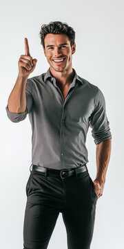 Full length studio portrait of a handsome smiling businessman in shirt and trousers standing while pointing his finger up with an idea