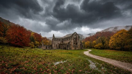 Obraz premium Ancient abbey ruins standing in autumn landscape under dramatic storm clouds for historical travel background