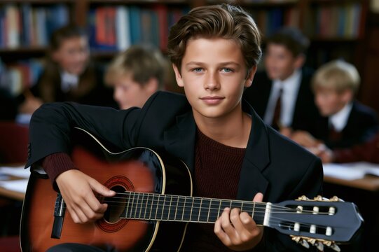 Boy student playing acoustic guitar in library