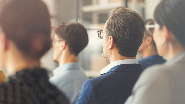 Businesspeople listening to a presentation during a business seminar