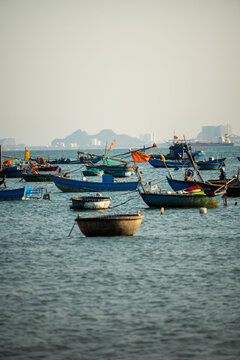 Many traditional fishermen boats staying on anchors at bay in Vietnam after morning fresh seafood catch, fishing fleet of local fishermen with nets and rods,, seafood boats for marine produce.