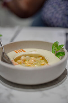 Chickpeas hummus served on a small plate in a restaurant