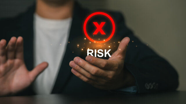 Businessman Displaying Risk Concept with Red Cross Icon and "Risk" Text