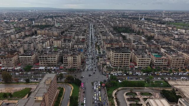 Aerial drone view of tourism police vehicles and officers in Aleppo, Syria. Syrian tourism police convoy driving through city streets after the fall of Bashar al-Assad. New Syrian government security 