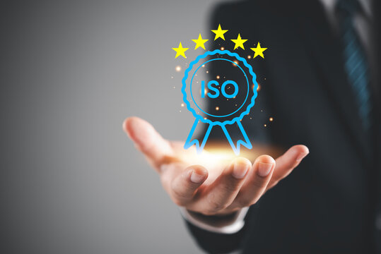 Businessman holding glowing ISO certification standard badge five stars icon smart composite premium quality guarantee business excellence corporate compliance management system strategy