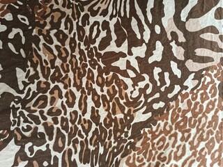 Animal print fabric texture background with leopard and tiger patterns © MixK