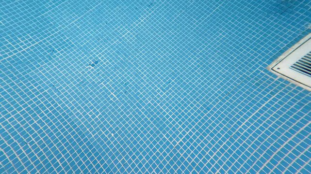 Underwater Tracking Shot Showing Detailed Swimming Pool Tile Texture