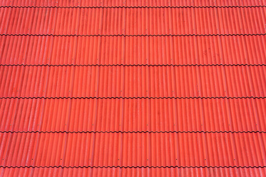 Vibrant red corrugated roof tiles background texture pattern