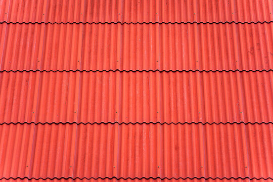 Vibrant red corrugated roof tiles background texture pattern