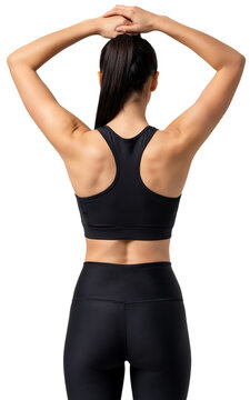 Woman's back view stretching arms overhead in black sports bra and leggings with cool down white background one person