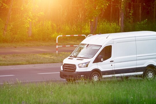 Clean white van driving through peaceful countryside