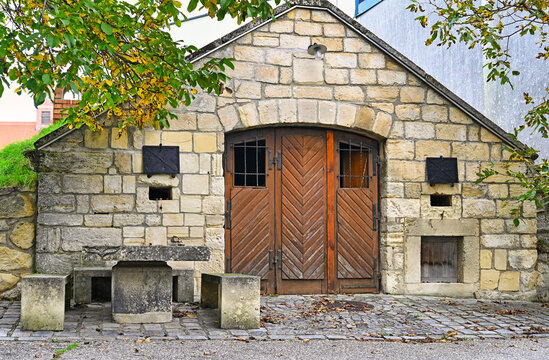 Traditional stone wine cellars in the historic Kellergasse of Purbach am Neusiedler See during autumn, Burgenland, Austria