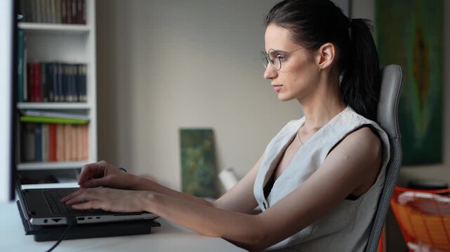 Woman using laptop while working from home