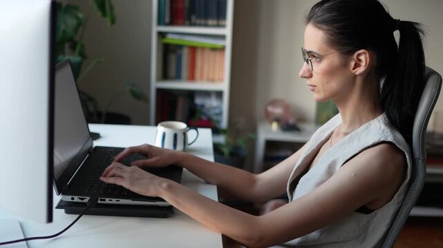 Young businesswoman working on a laptop in a home office