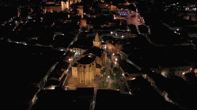Night aerial orbit around the Church of San Francisco Javier and Plaza de San Jorge