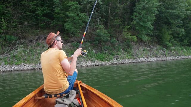 Side view of man in recreational fishing on peaceful lake