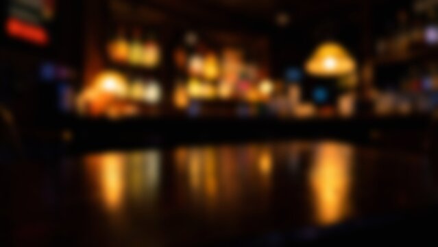 Blurred bokeh lights reflecting on a dark wooden bar counter in a pub interior background for product placement mockups and beverage advertising composites