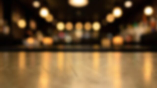 Blurred bokeh lights background in cozy night cafe with empty wooden table surface for product placement mockup and drink presentation