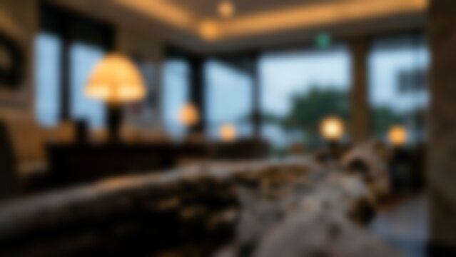 Blurred interior bokeh background of a cozy modern living room lounge with warm lighting, ideal for presentation backdrops and real estate marketing banners