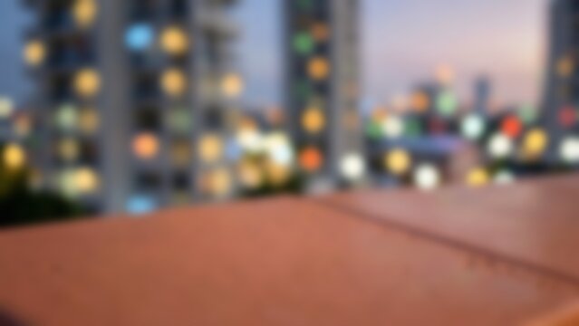Empty red clay tile balcony ledge against a blurred evening cityscape with colorful bokeh lights for urban product placement and design mockups